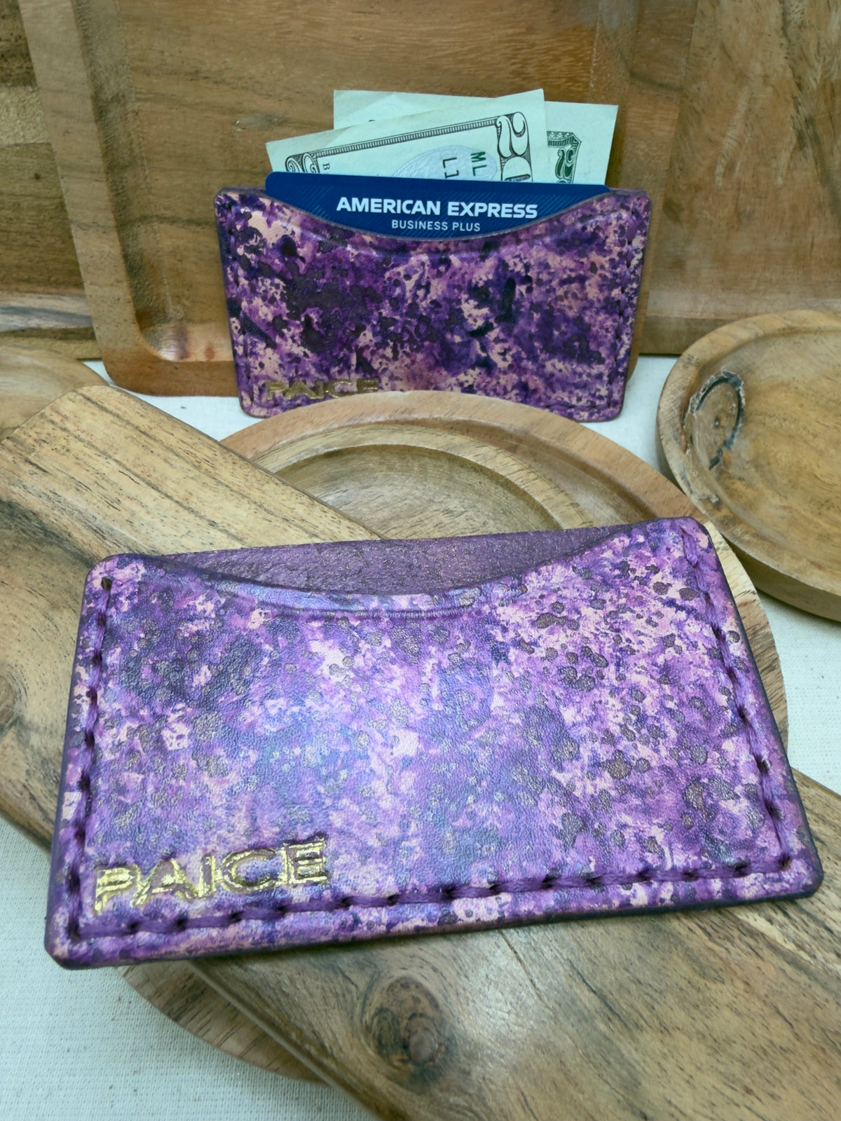 Purple marbled single-pocket card wallet with gold PAICE logo, shown with a card and cash
