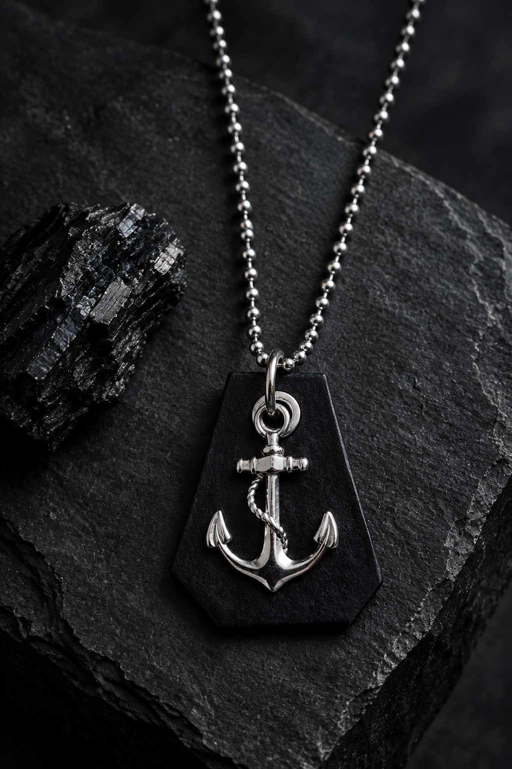 Anchor pendant necklace styled on charcoal stone