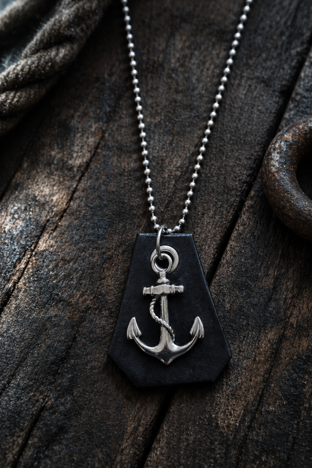 Anchor pendant necklace styled on weathered wood