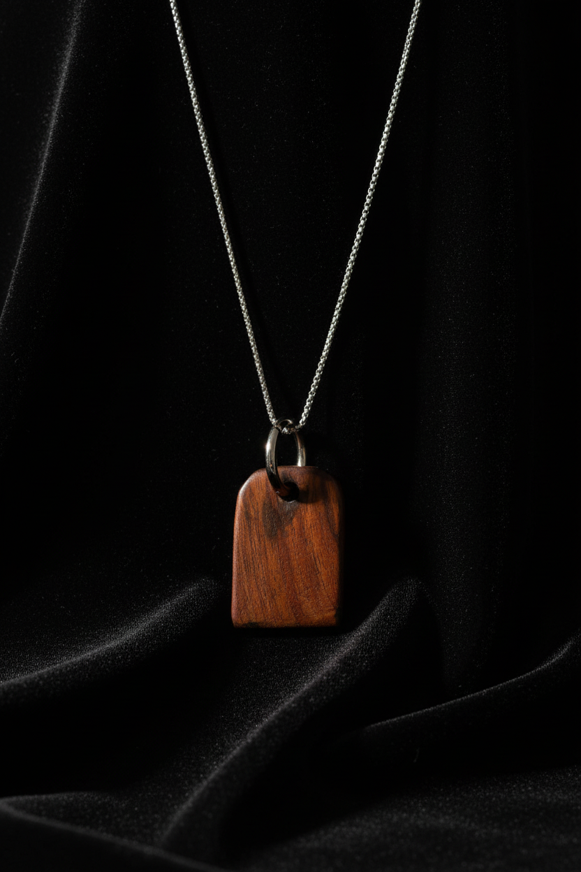Close-up wood pendant necklace on black velvet