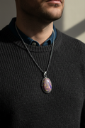 Pendant necklace on a man in a charcoal sweater
